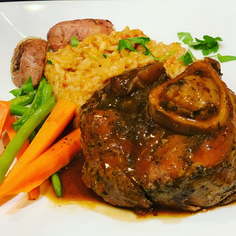 Pavesi Restaurant's osso buco with risotto, roasted potatoes, carrots, and green beans.
